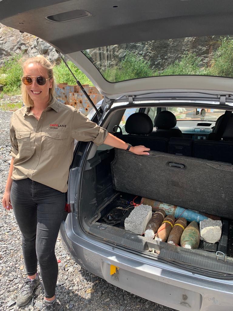 Project Executive Bryony Broadman with a car boot full of explosive ordnance 